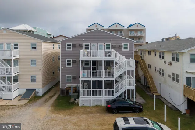 a front view of a house with a parking space