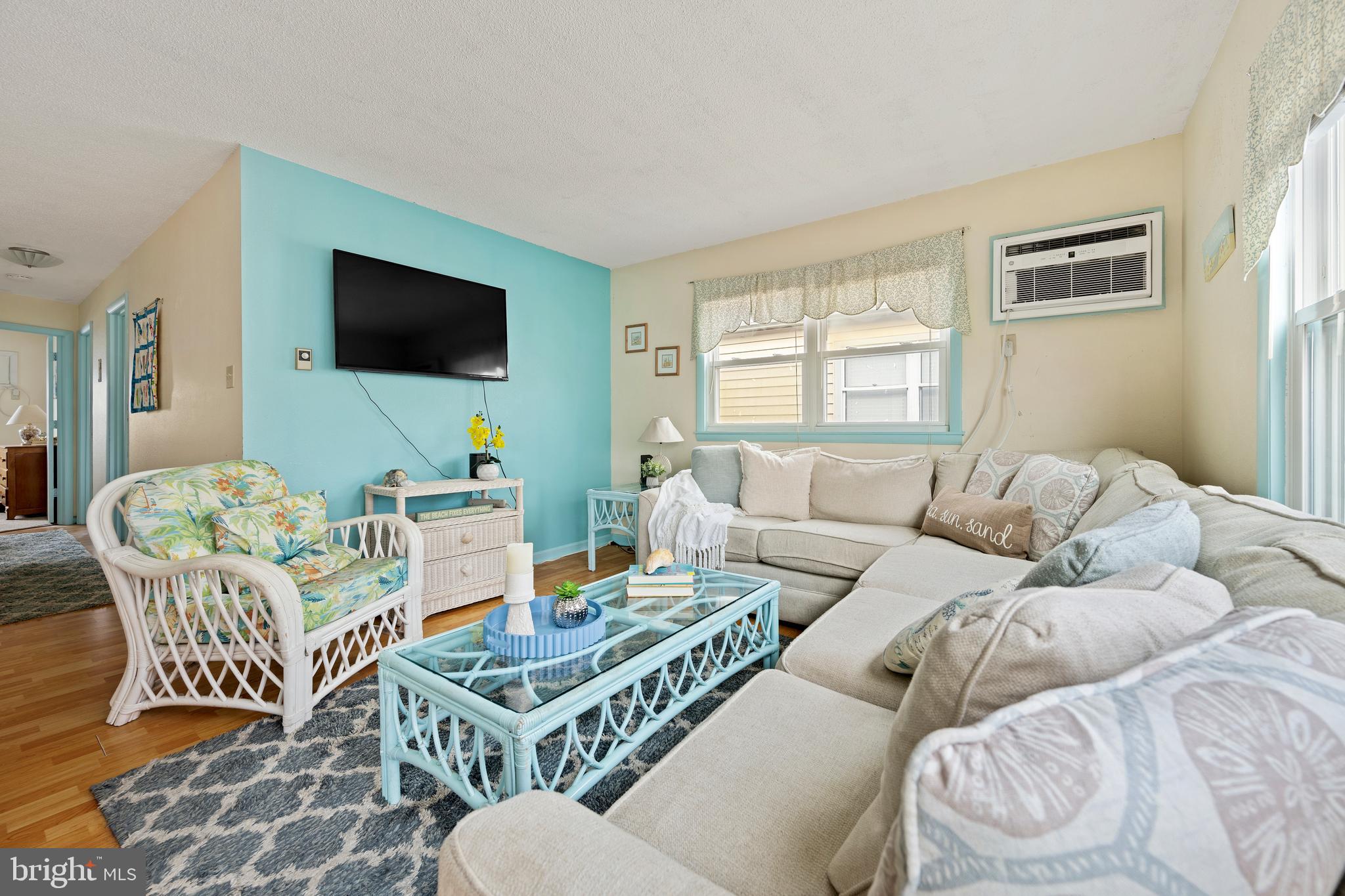 9 79th Street, Unit 3W Ocean City, MD 21842 - Photo 3 of 34 a living room with furniture and a flat screen tv