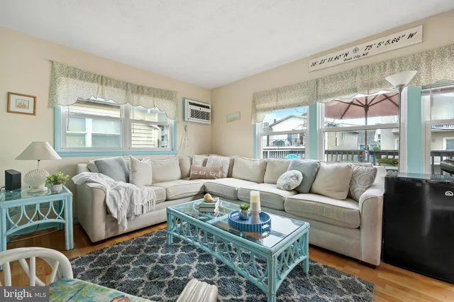 a living room with furniture a rug and a large window