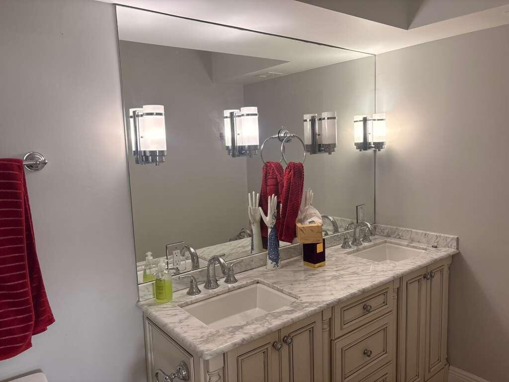2611 North Riverside Drive, Unit 703 Pompano Beach, FL 33062 - Photo 29 of 81 a bathroom with a granite countertop sink and a mirror