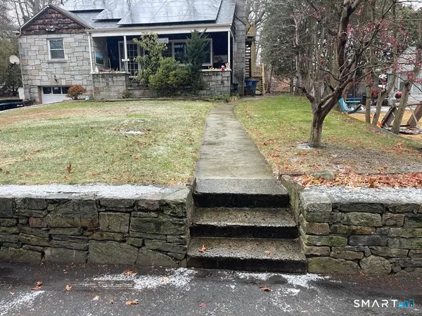 a view of a backyard with wooden fence