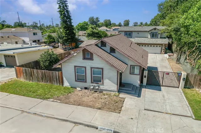a aerial view of a house next to a yard