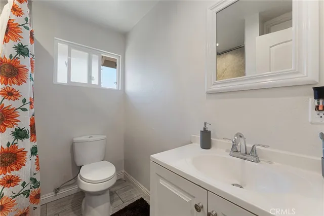 a bathroom with a sink a toilet and mirror