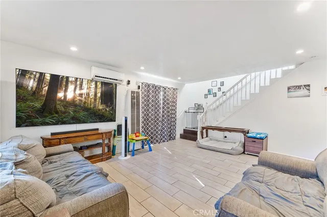 a bedroom with furniture and a flat screen tv