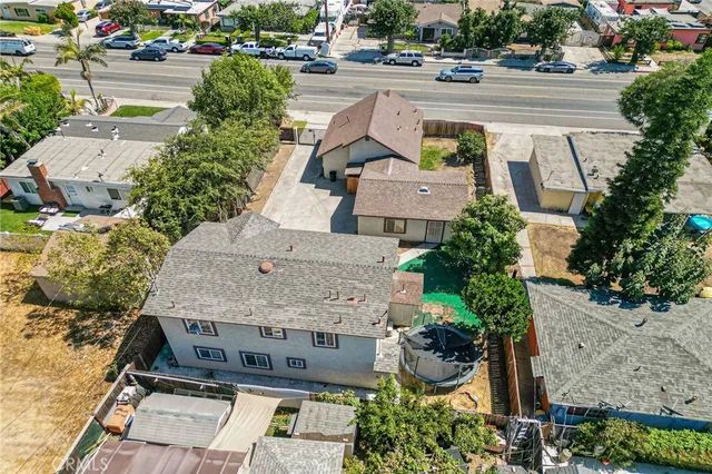 an aerial view of a house with garden space and street view