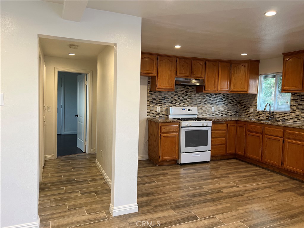 9127 Greenleaf Avenue Whittier, CA 90602 - Photo 6 of 39 a kitchen with stainless steel appliances kitchen island granite countertop a stove and a sink