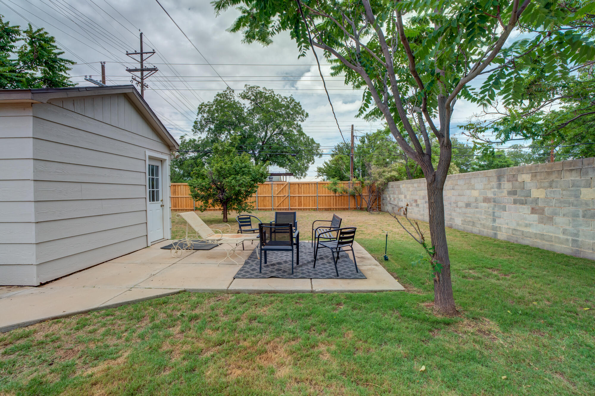 2826 33rd Street Lubbock, TX 79410 - Photo 28 of 33 a view of a patio with table and chairs potted plants and large tree