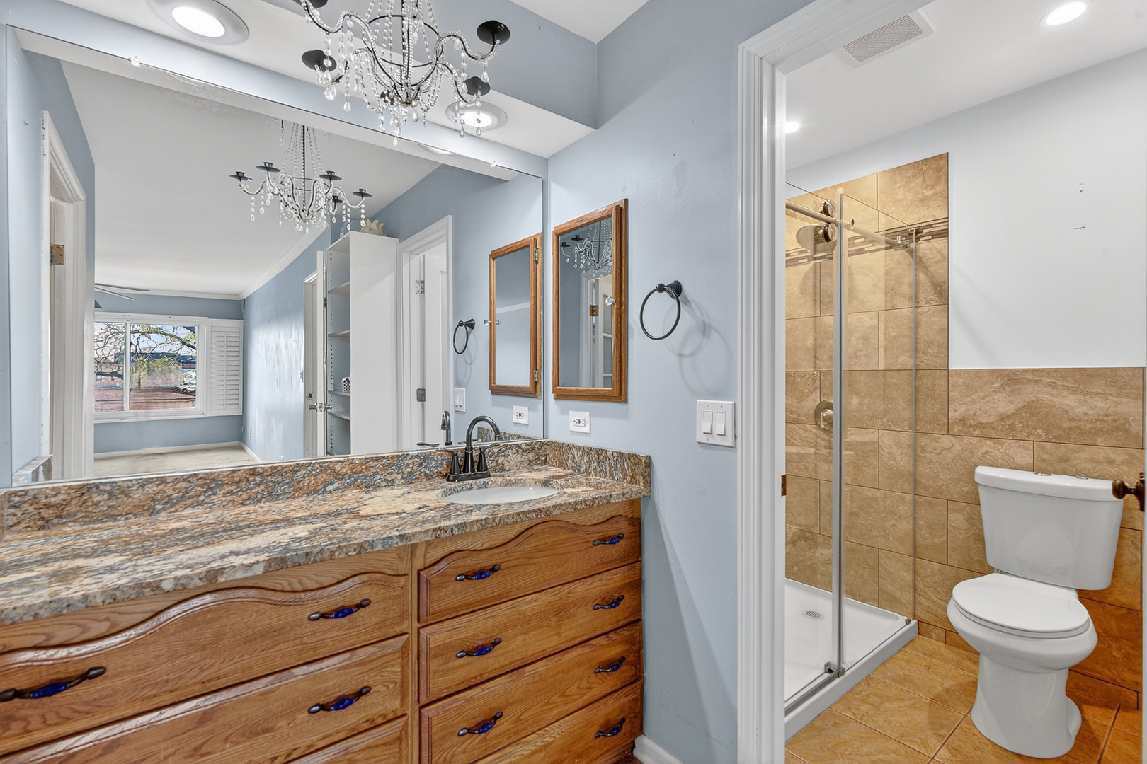 500 West Huntington Commons Road, Unit 253 Mount Prospect, IL 60056 - Photo 13 of 24 a bathroom with a granite countertop sink toilet and shower