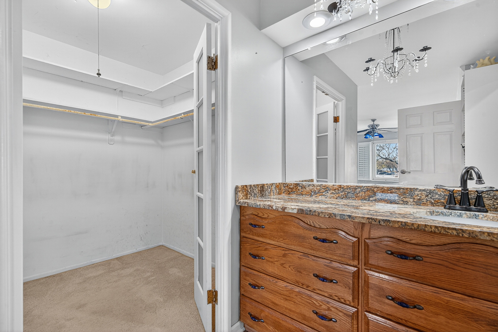 500 West Huntington Commons Road, Unit 253 Mount Prospect, IL 60056 - Photo 15 of 24 a bathroom with a granite countertop sink a mirror and shower