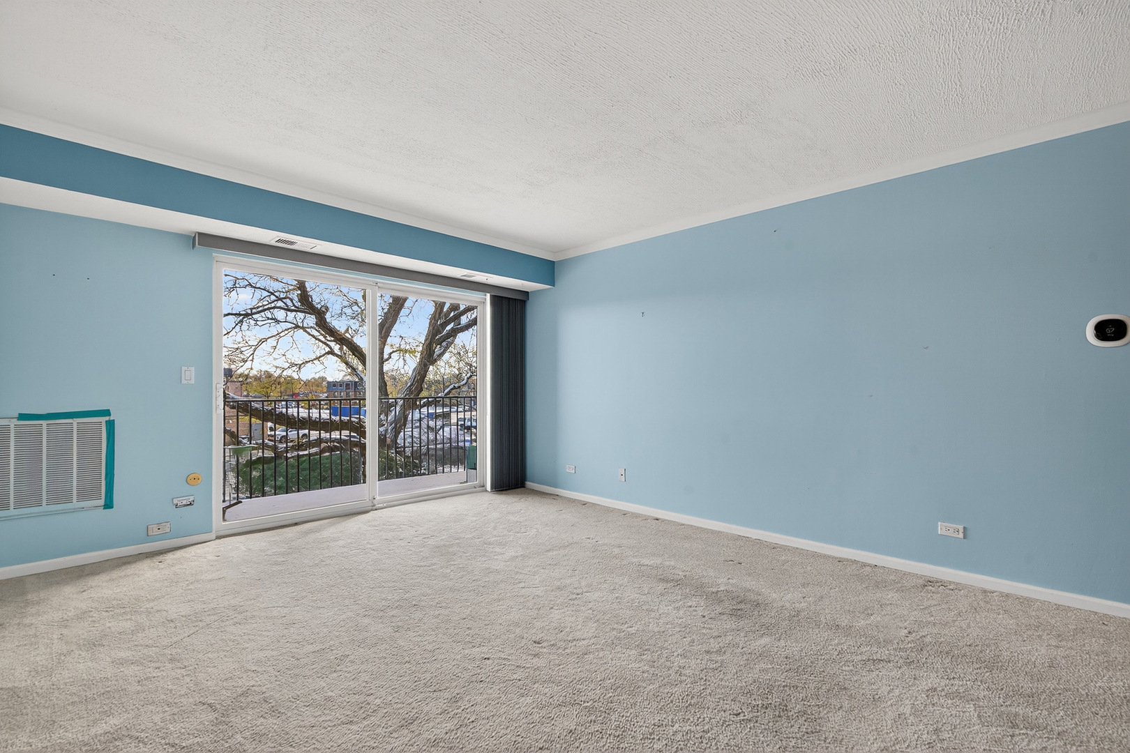 500 West Huntington Commons Road, Unit 253 Mount Prospect, IL 60056 - Photo 3 of 24 an empty room with large windows