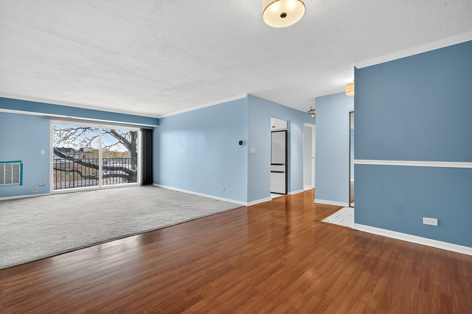 500 West Huntington Commons Road, Unit 253 Mount Prospect, IL 60056 - Photo 5 of 24 a view of a livingroom with wooden floor and a window