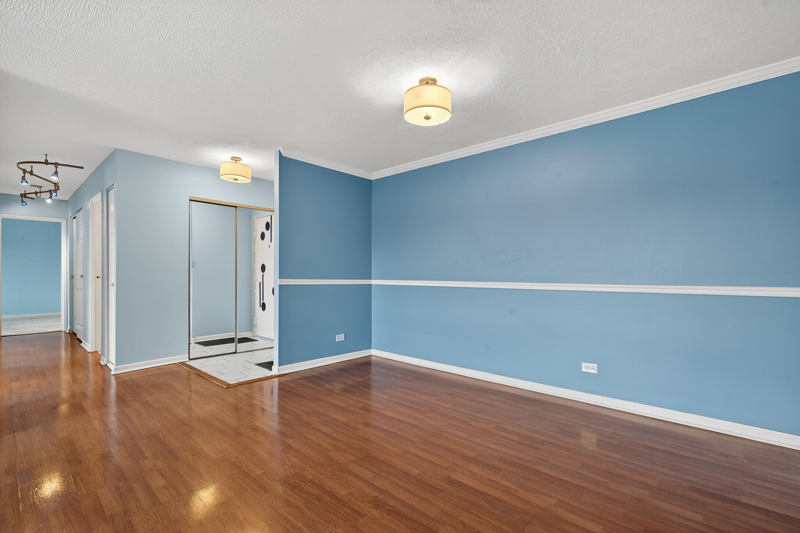500 West Huntington Commons Road, Unit 253 Mount Prospect, IL 60056 - Photo 6 of 24 a view of an empty room with wooden floor
