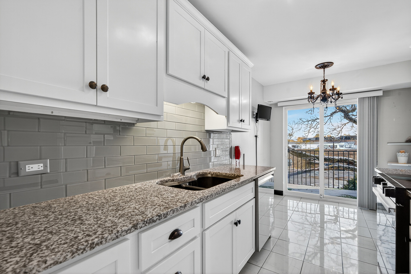 500 West Huntington Commons Road, Unit 253 Mount Prospect, IL 60056 - Photo 7 of 24 a kitchen with granite countertop a sink a stove and cabinets