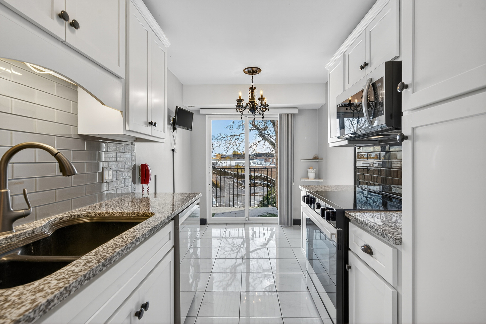 500 West Huntington Commons Road, Unit 253 Mount Prospect, IL 60056 - Photo 8 of 24 a kitchen with stainless steel appliances granite countertop a sink stove and cabinets