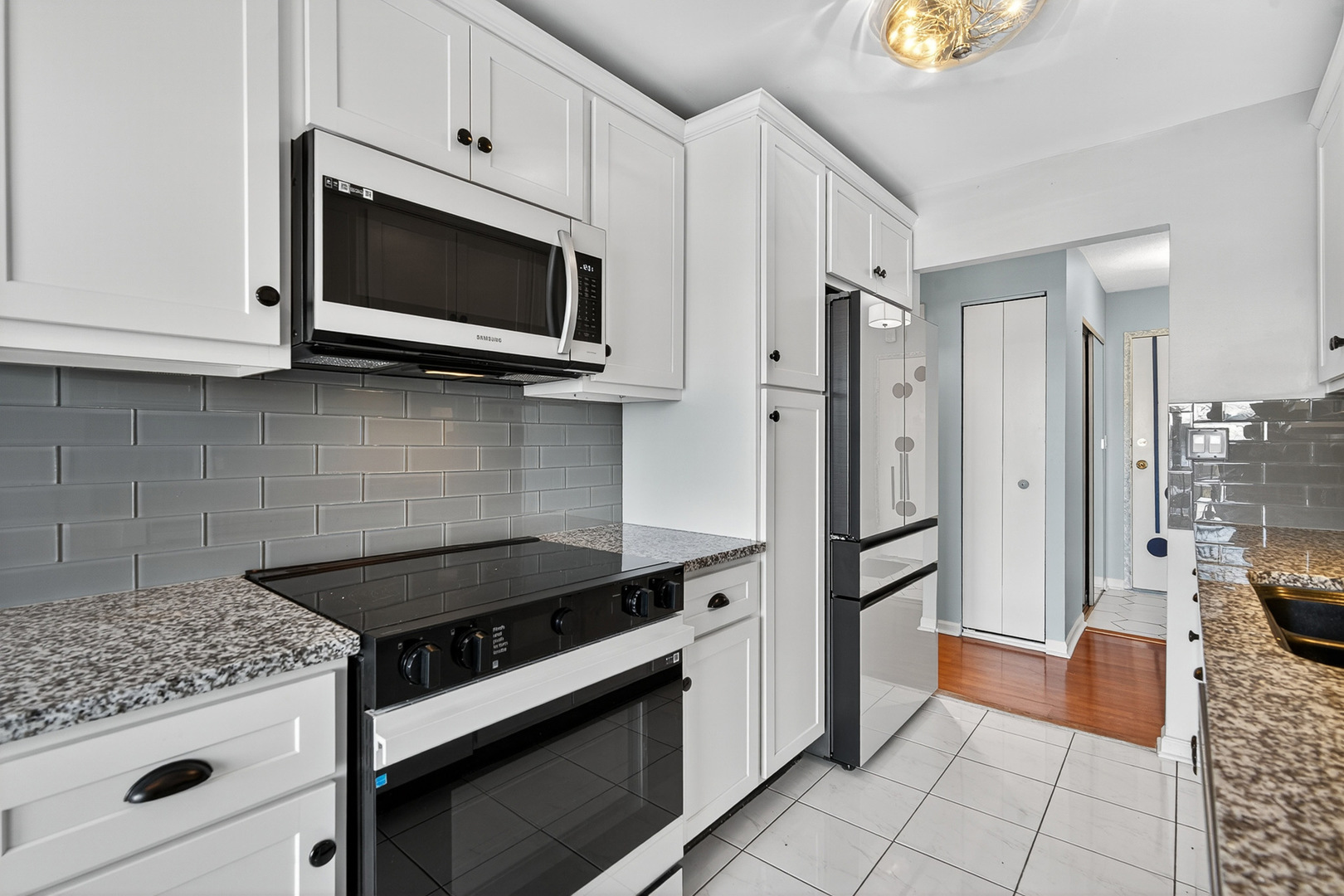 500 West Huntington Commons Road, Unit 253 Mount Prospect, IL 60056 - Photo 9 of 24 a kitchen with stainless steel appliances granite countertop a stove a microwave and a refrigerator
