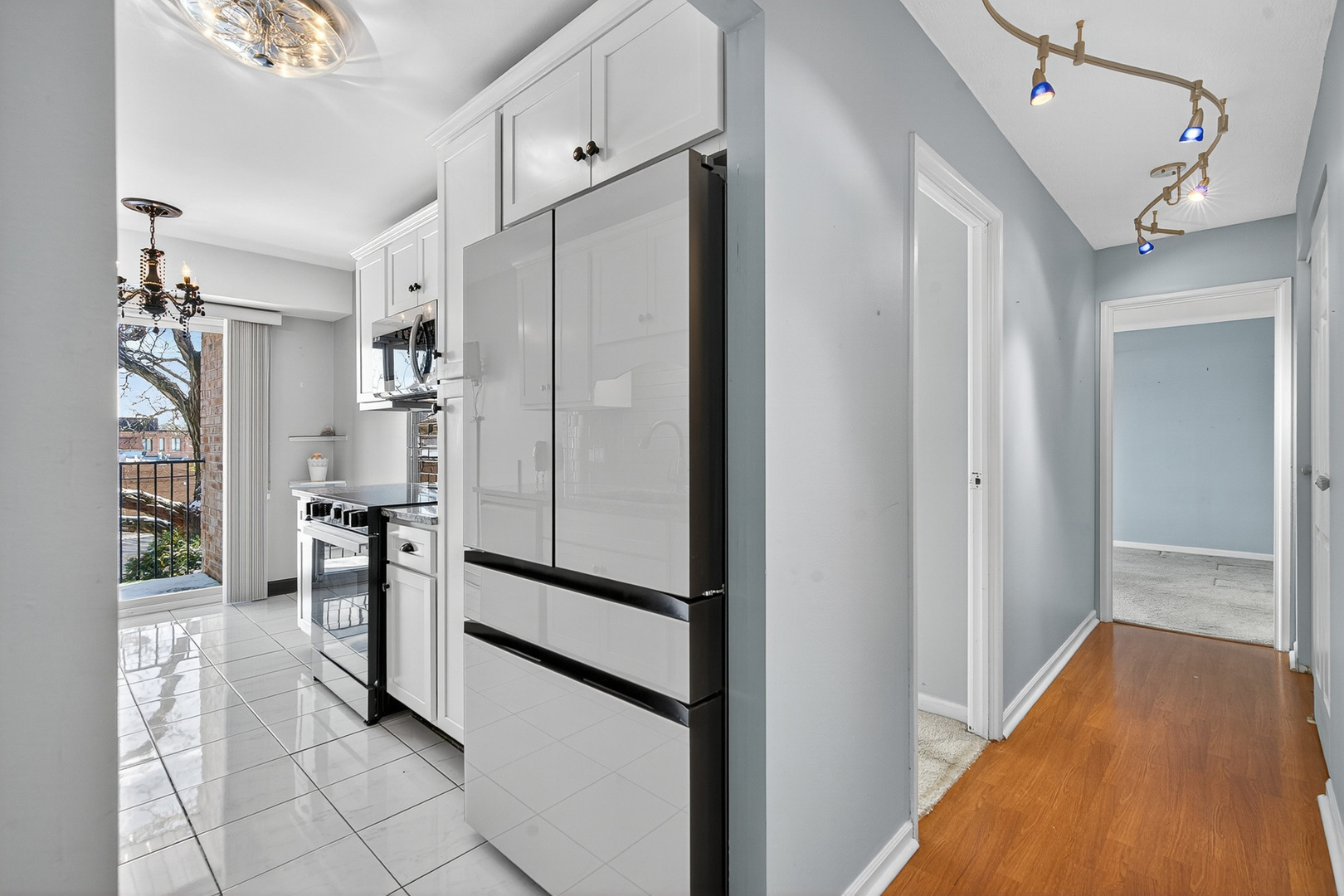 500 West Huntington Commons Road, Unit 253 Mount Prospect, IL 60056 - Photo 10 of 24 a view of hallway with cabinets and refrigerator