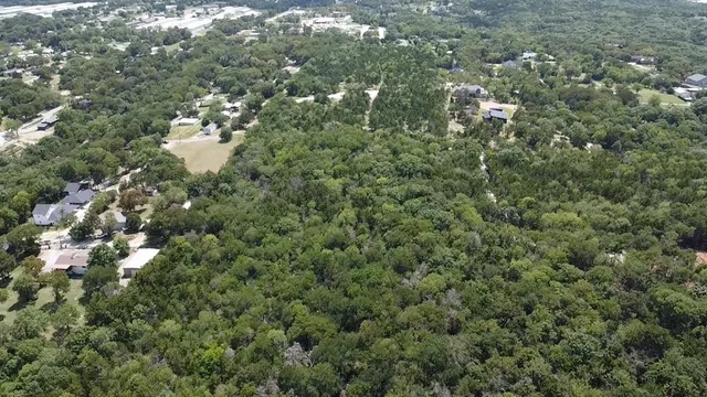 an aerial view of lake and residential houses with outdoor space