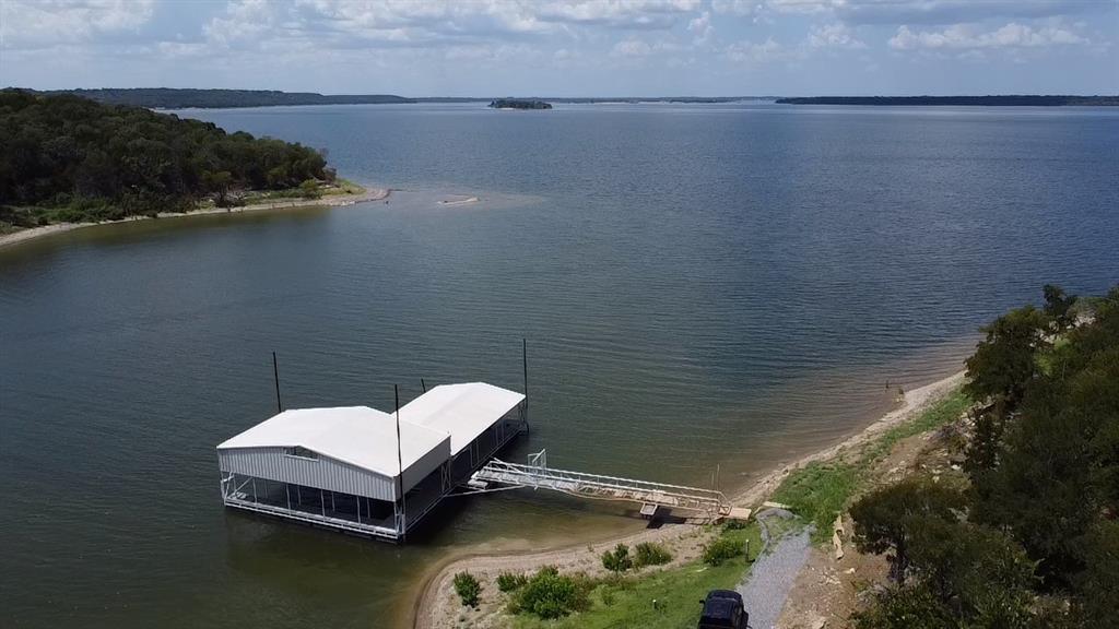 Tbd 3rd Street Pottsboro, TX 75076 - Photo 5 of 31 a small white house with a white pool and wooden floor