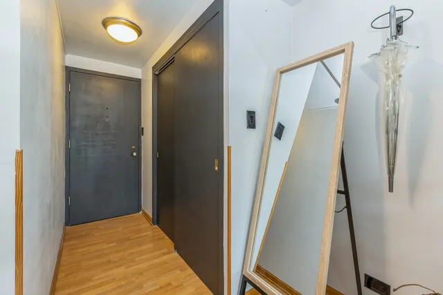 a view of a hallway with a door and stairs