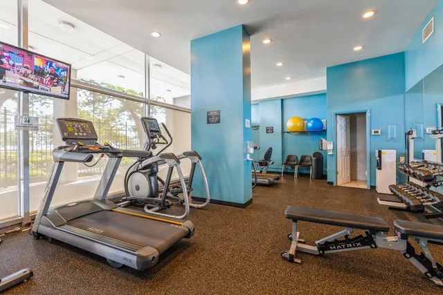 a room with gym equipment and windows
