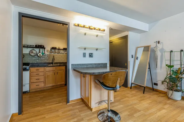 a en suite bathroom with a granite countertop sink and a mirror