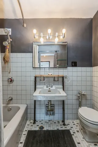 a bathroom with a sink a toilet and bathtub