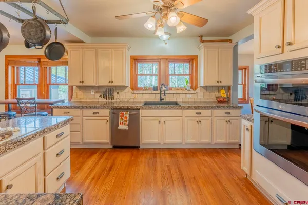 a kitchen with a sink window and stainless steel appliances