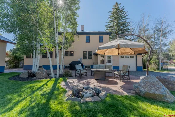 a swimming pool with outdoor seating outdoor seating and yard