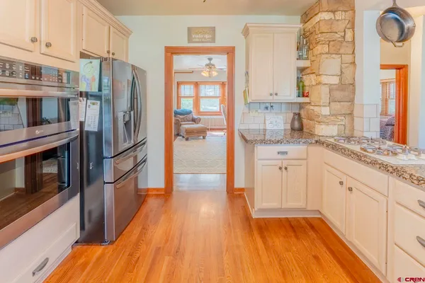 a kitchen with stainless steel appliances a refrigerator and a stove