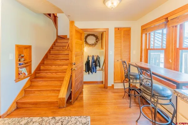 a view of an entryway with wooden floor and door