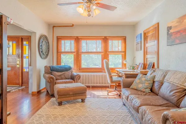 a living room with furniture and a large window
