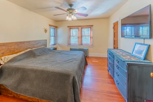 a spacious bedroom with a bed and a chandelier