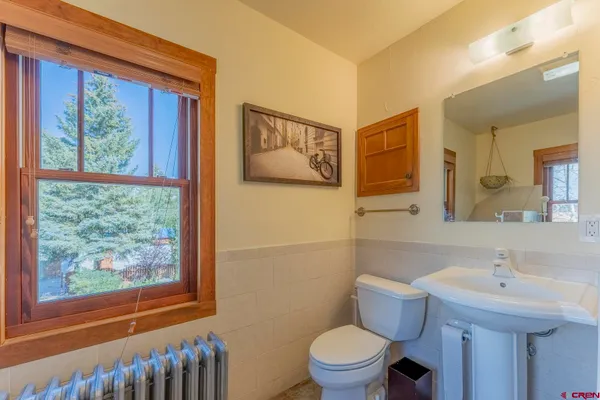 a bathroom with a blue sink sitting next to a toilet