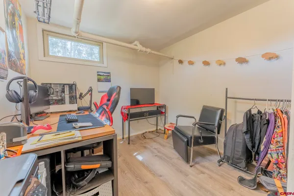 a view of a workspace with furniture and a window