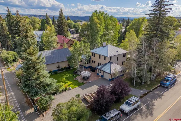 an aerial view of a house with yard swimming pool and outdoor seating