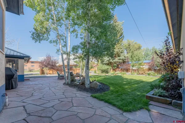 a view of backyard with plants and outdoor seating