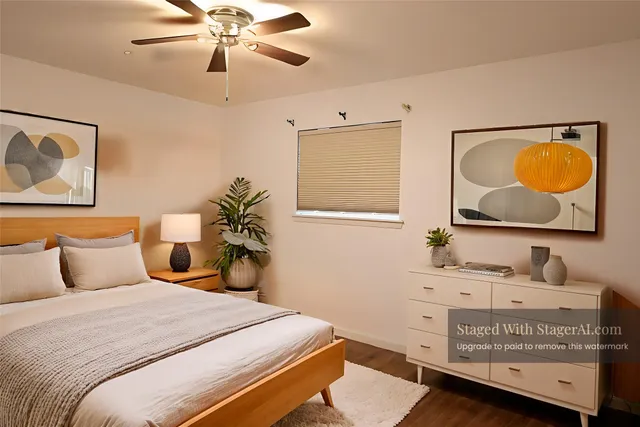 a bedroom with a bed and a lamp on the dresser