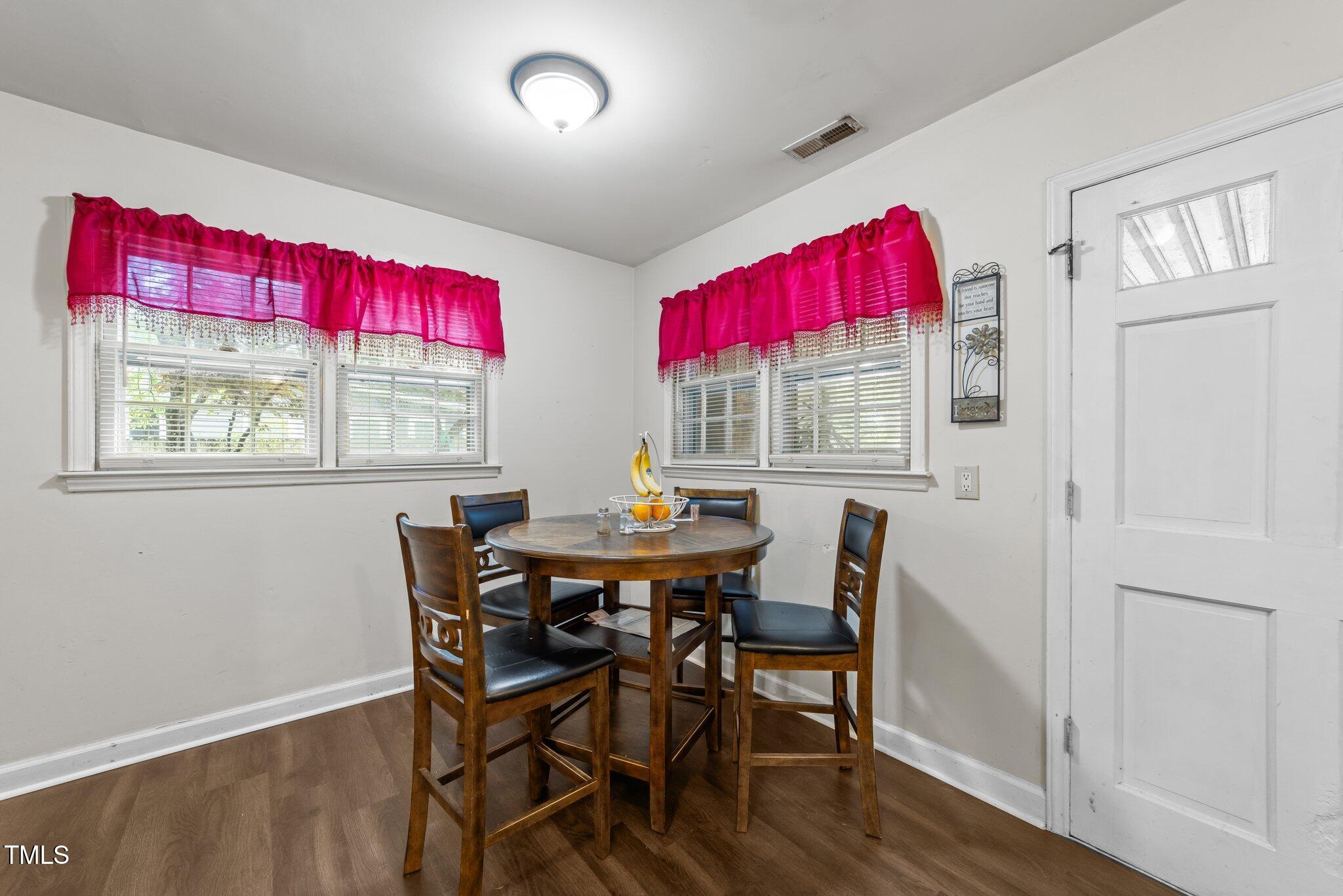 313 Colleton Road Raleigh, NC 27610 - Photo 12 of 32 a view of a dining room with furniture window and wooden floor