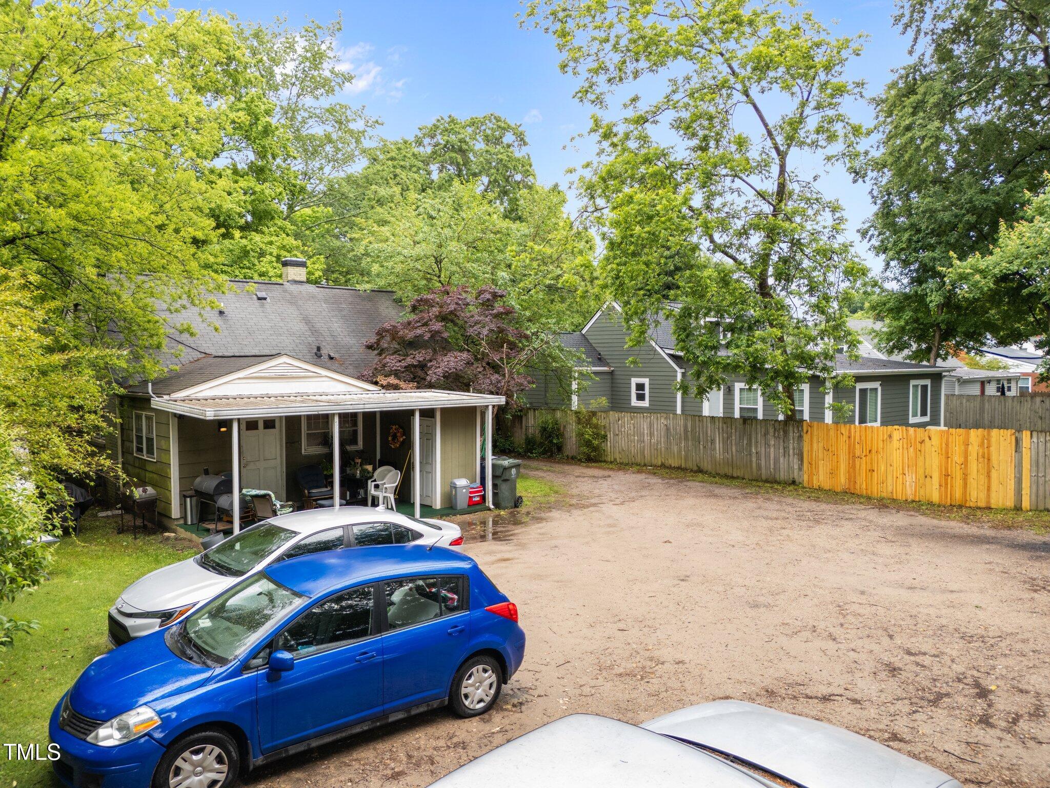 313 Colleton Road Raleigh, NC 27610 - Photo 25 of 32 a car parked in front of a house with a yard