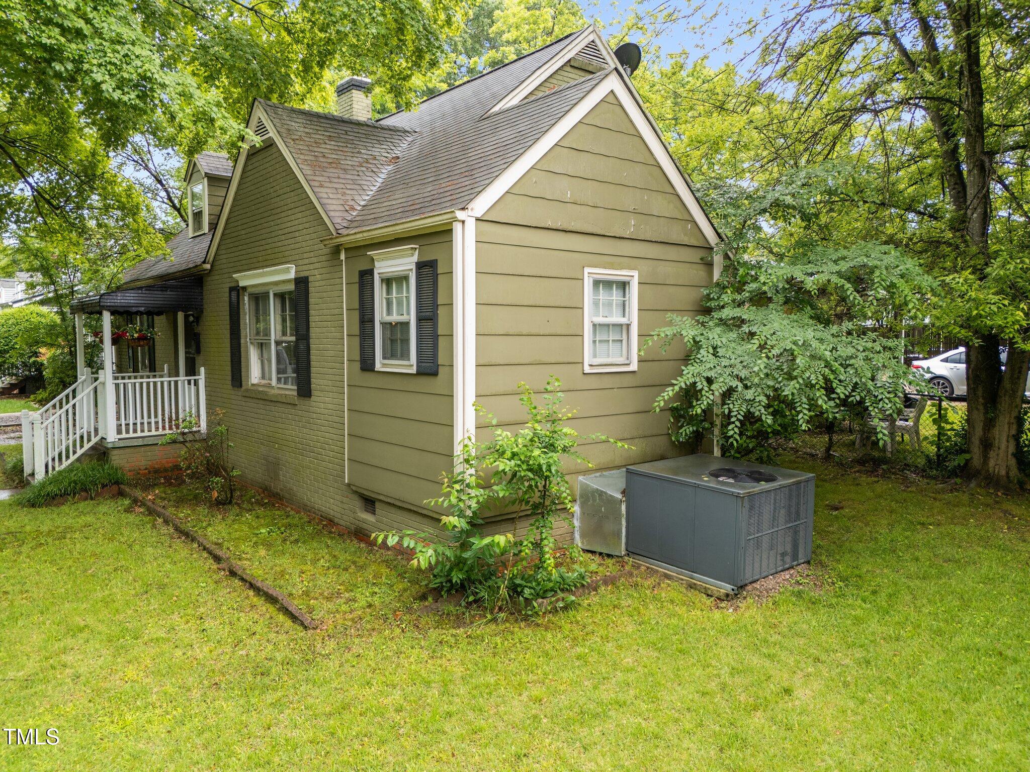 313 Colleton Road Raleigh, NC 27610 - Photo 26 of 32 a view of backyard with potted plants and a large tree