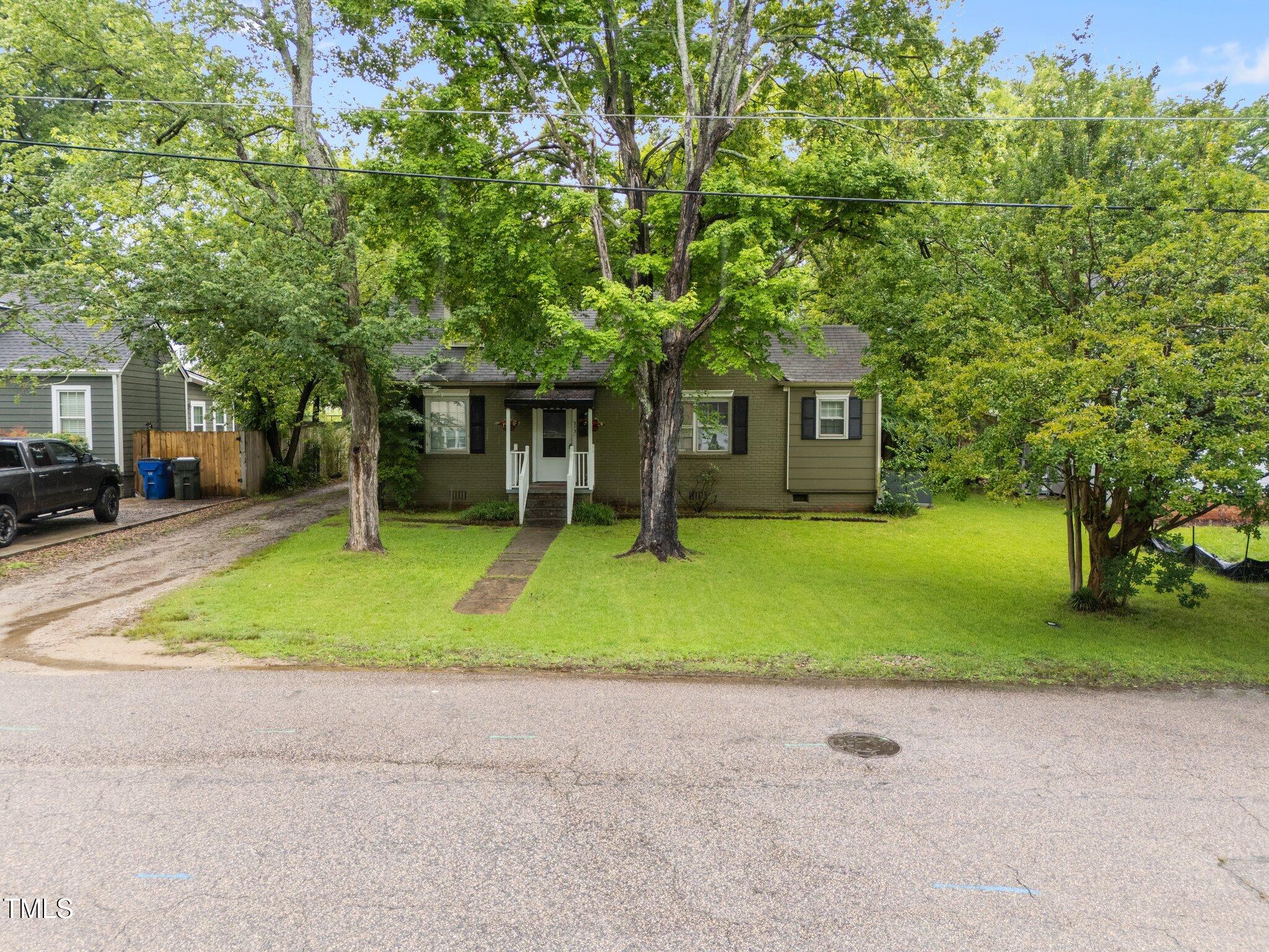 313 Colleton Road Raleigh, NC 27610 - Photo 28 of 32 a front view of house with yard and green space