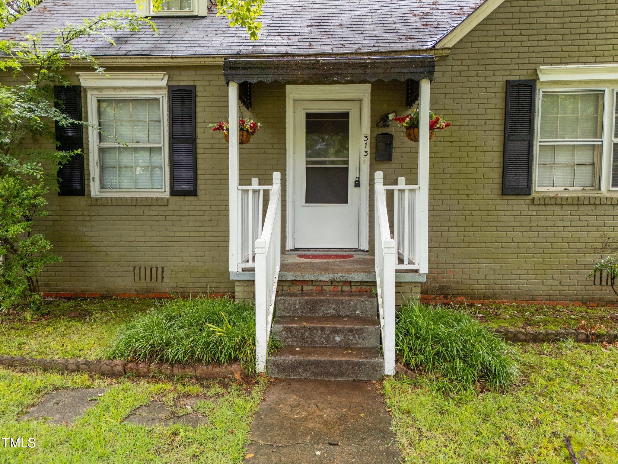 313 Colleton Road Raleigh, NC 27610 - Photo 3 of 32 a view of a house with potted plants