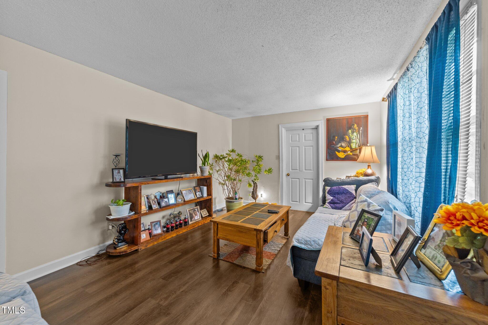 313 Colleton Road Raleigh, NC 27610 - Photo 5 of 32 a living room with furniture and a flat screen tv