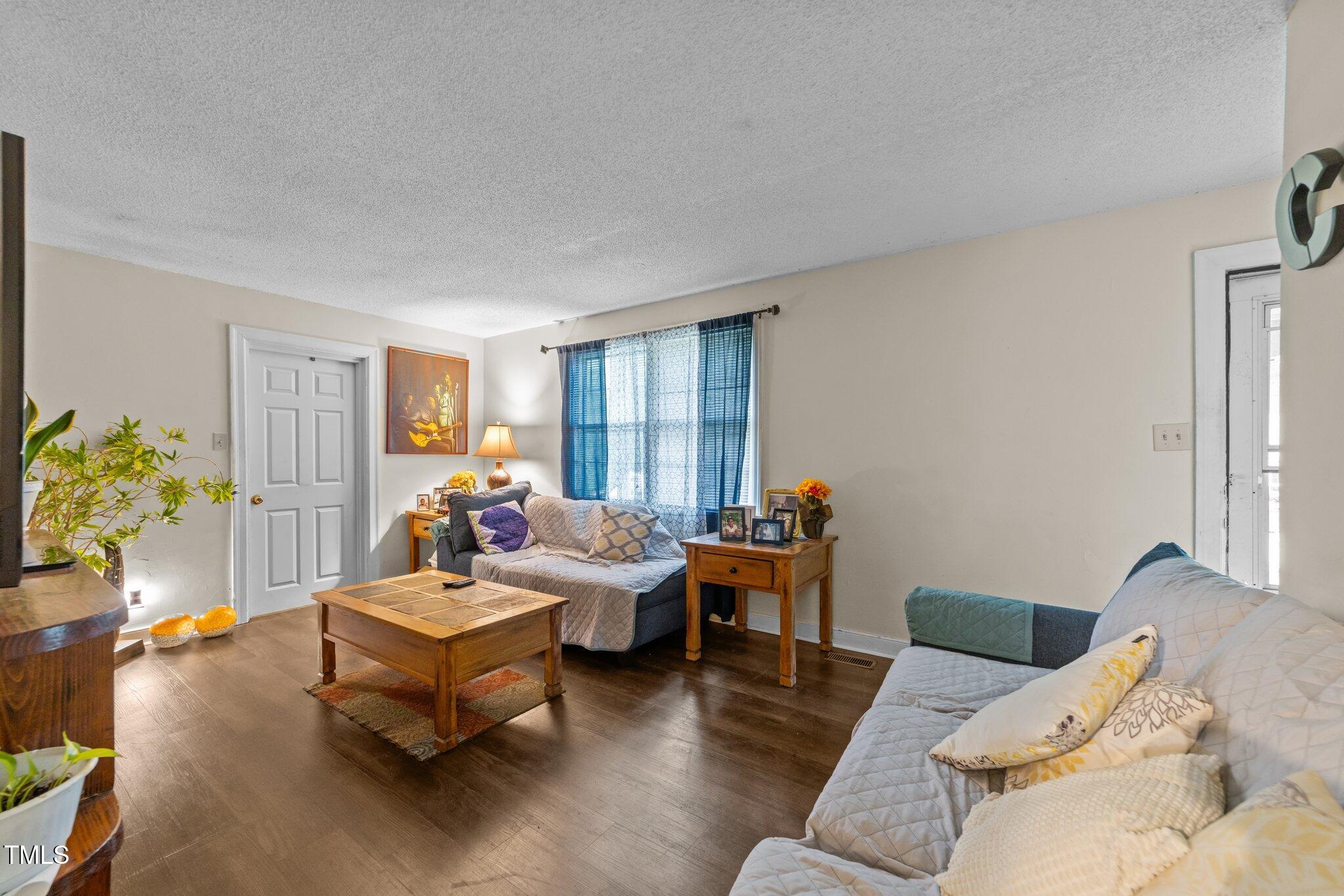 313 Colleton Road Raleigh, NC 27610 - Photo 6 of 32 a living room with furniture and a large window