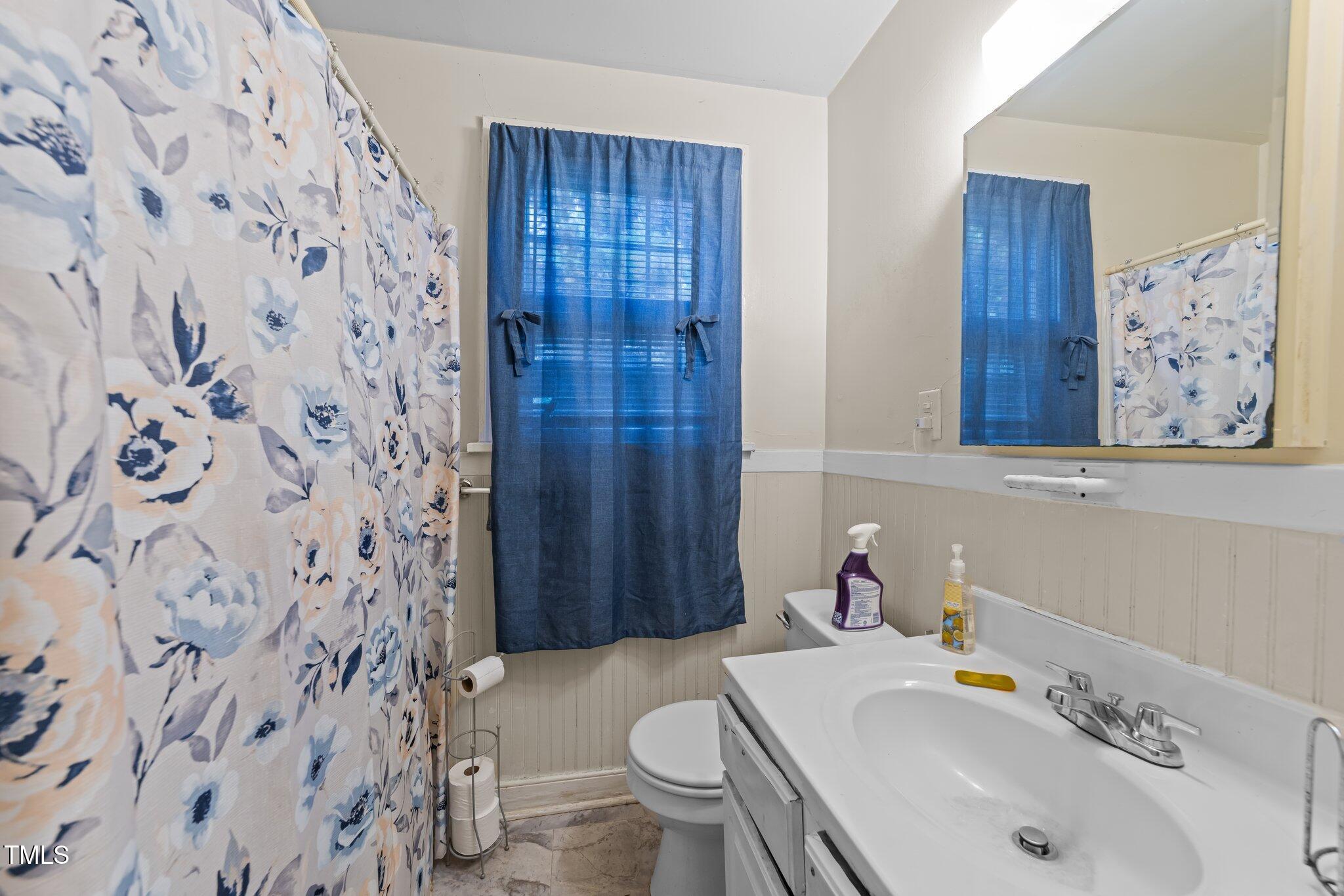 313 Colleton Road Raleigh, NC 27610 - Photo 7 of 32 a bathroom with a sink and toilet
