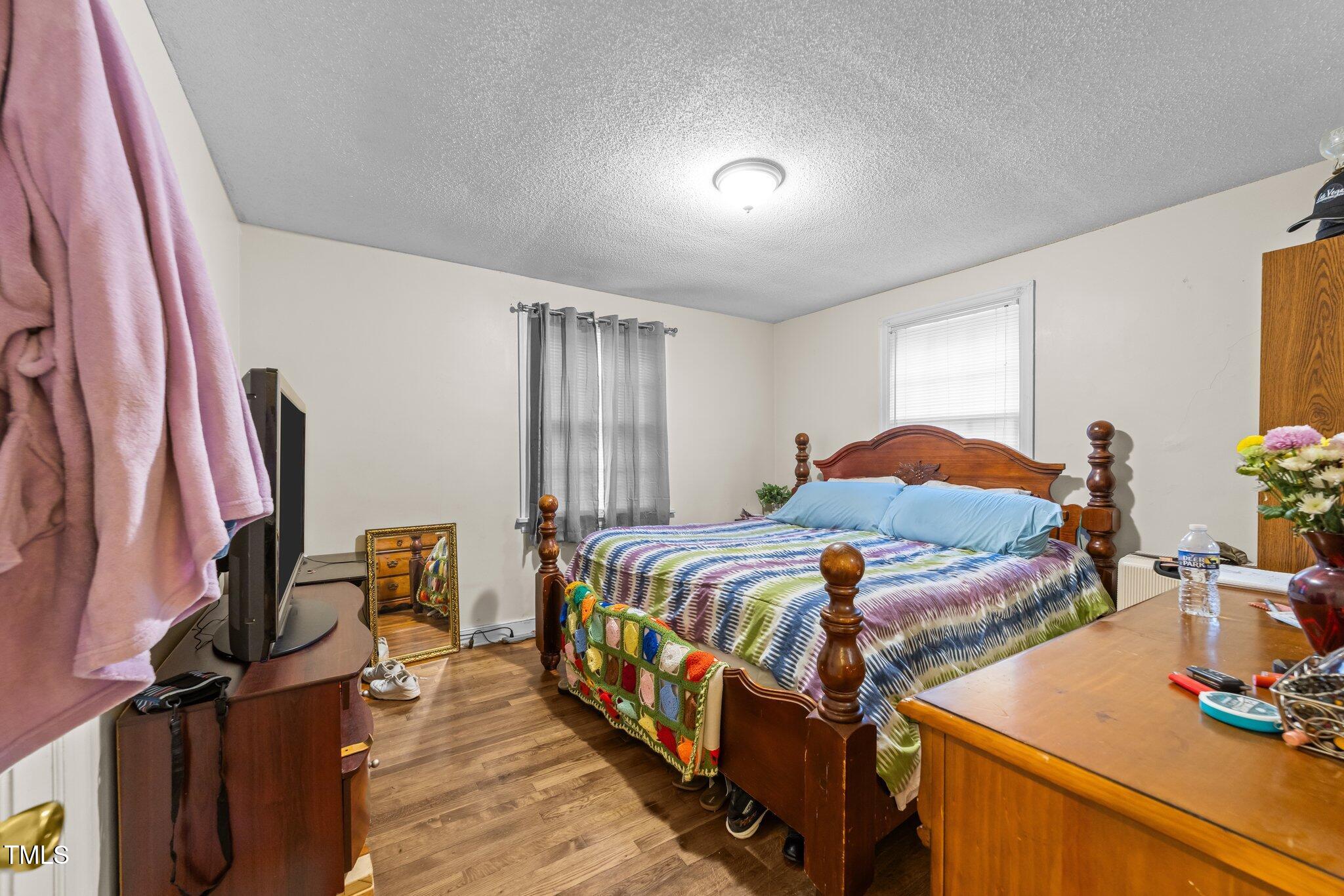 313 Colleton Road Raleigh, NC 27610 - Photo 8 of 32 a bedroom with bed and a window