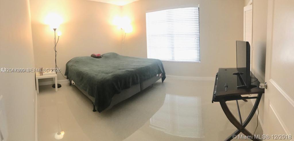 11447 Southwest 33rd Lane Miami, FL 33165 - Photo 3 of 8 a living room with a bed furniture and a window