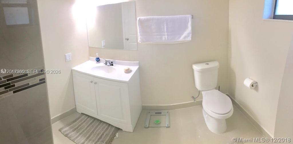 11447 Southwest 33rd Lane Miami, FL 33165 - Photo 4 of 8 a bathroom with a toilet sink and a mirror
