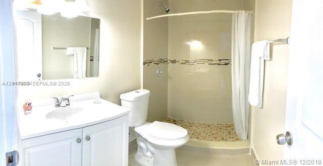 11447 Southwest 33rd Lane Miami, FL 33165 - Photo 7 of 8 a bathroom with a sink toilet and shower