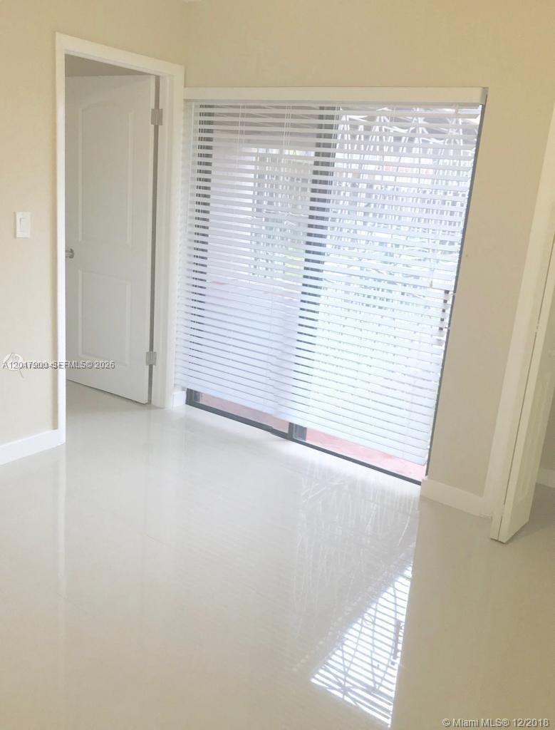 11447 Southwest 33rd Lane Miami, FL 33165 - Photo 8 of 8 an empty room with windows